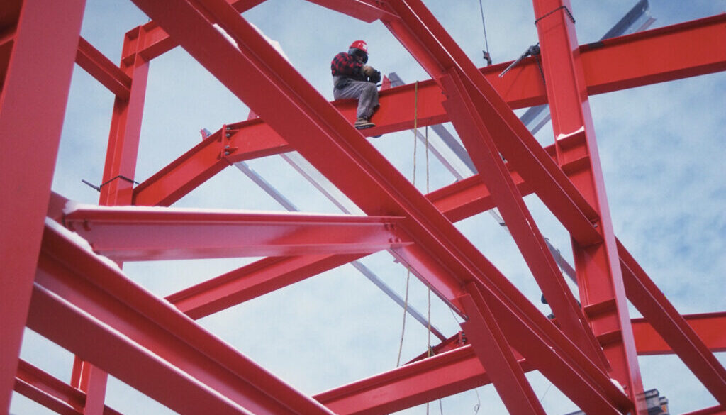 Construction Worker Sitting on Steel Beams